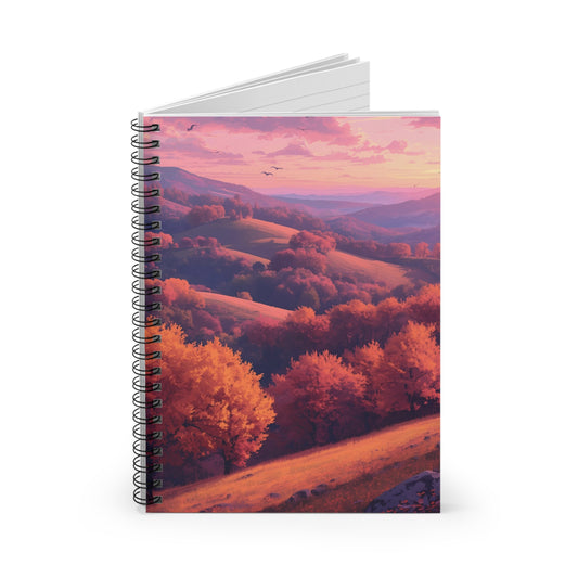 Notebook with a scenic cover of trees and mountains at sunset.