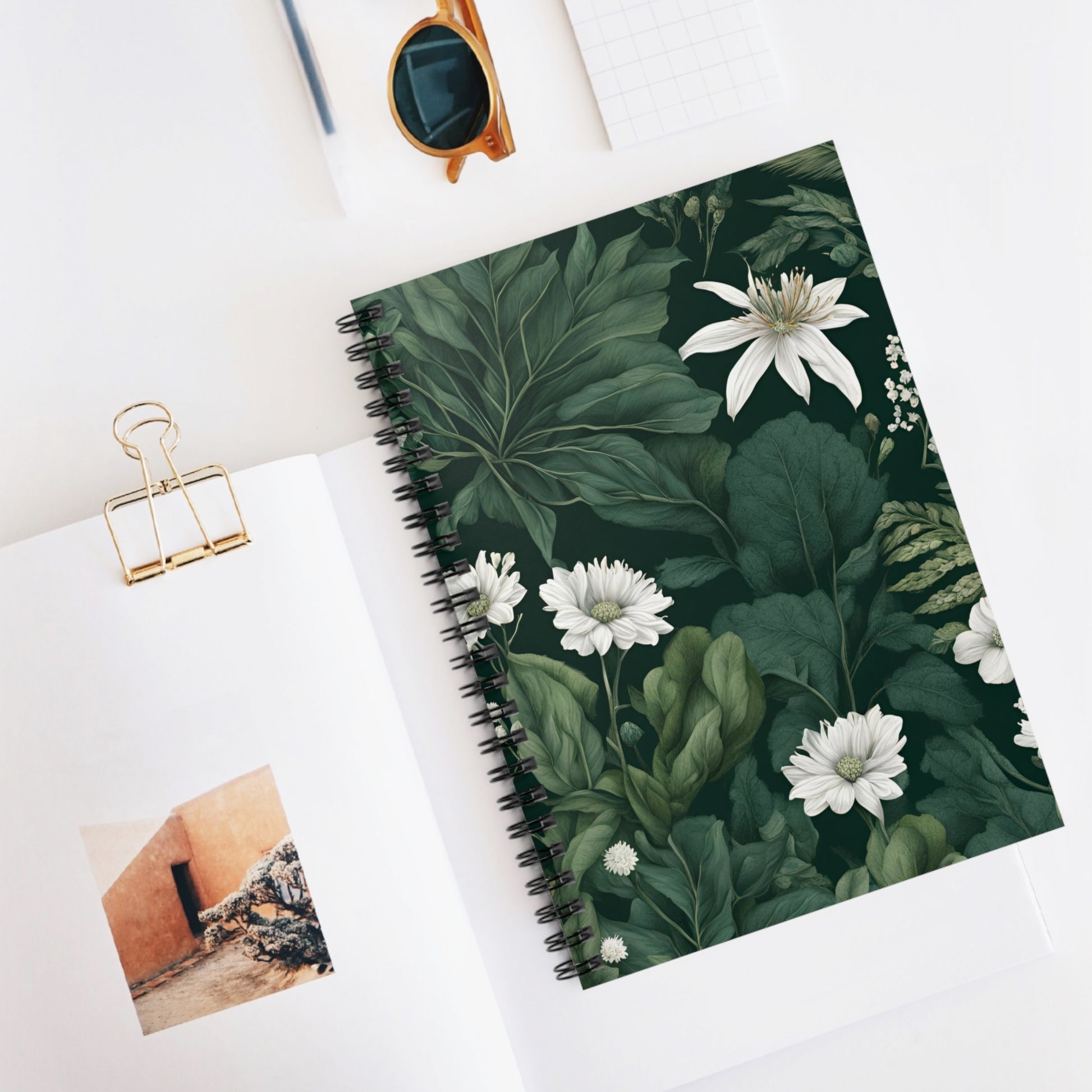 Notebook with floral design on a white surface