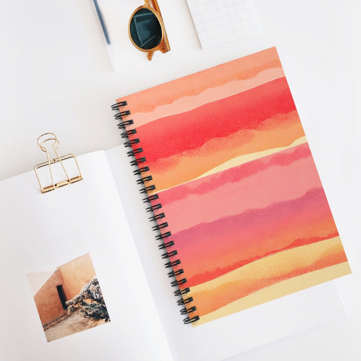 Spiral-bound notebook with a colorful cover on a white surface