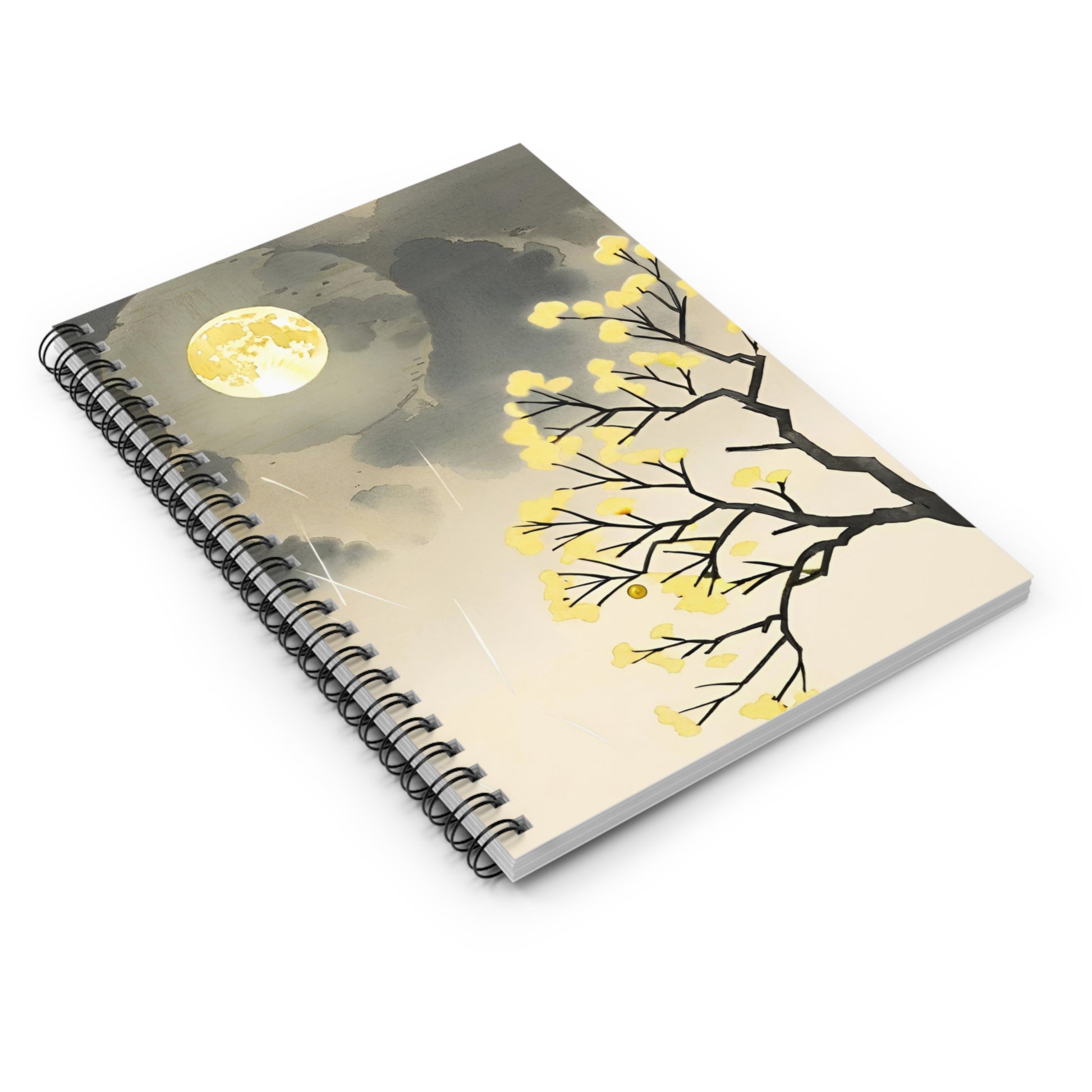 Notebook with a tree design and moon on the cover against a white background