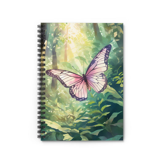 Notebook with a butterfly design on a green forest background
