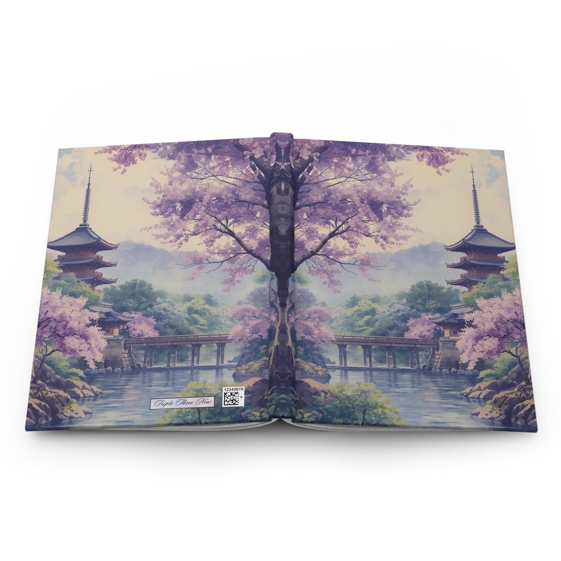 Open book with a scenic design of cherry blossoms and pagodas on a white background