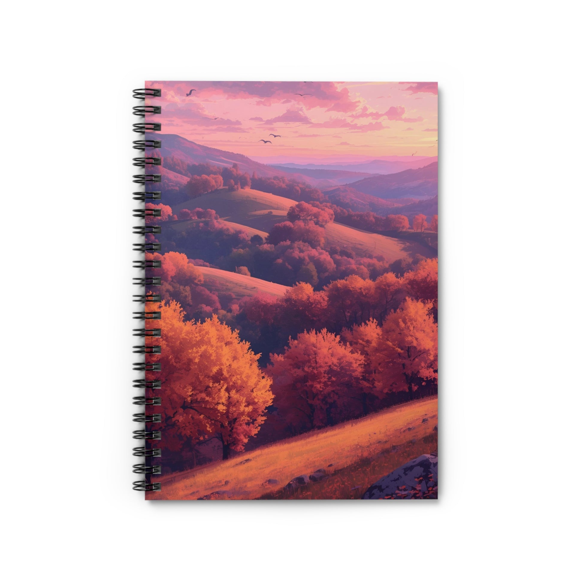 Notebook with a scenic cover of trees and mountains at sunset.