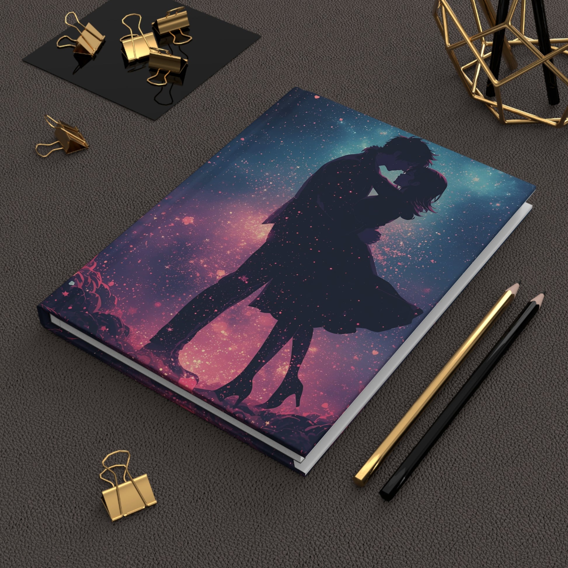 Notebook with a couple embracing design on a dark surface with stationery items.
