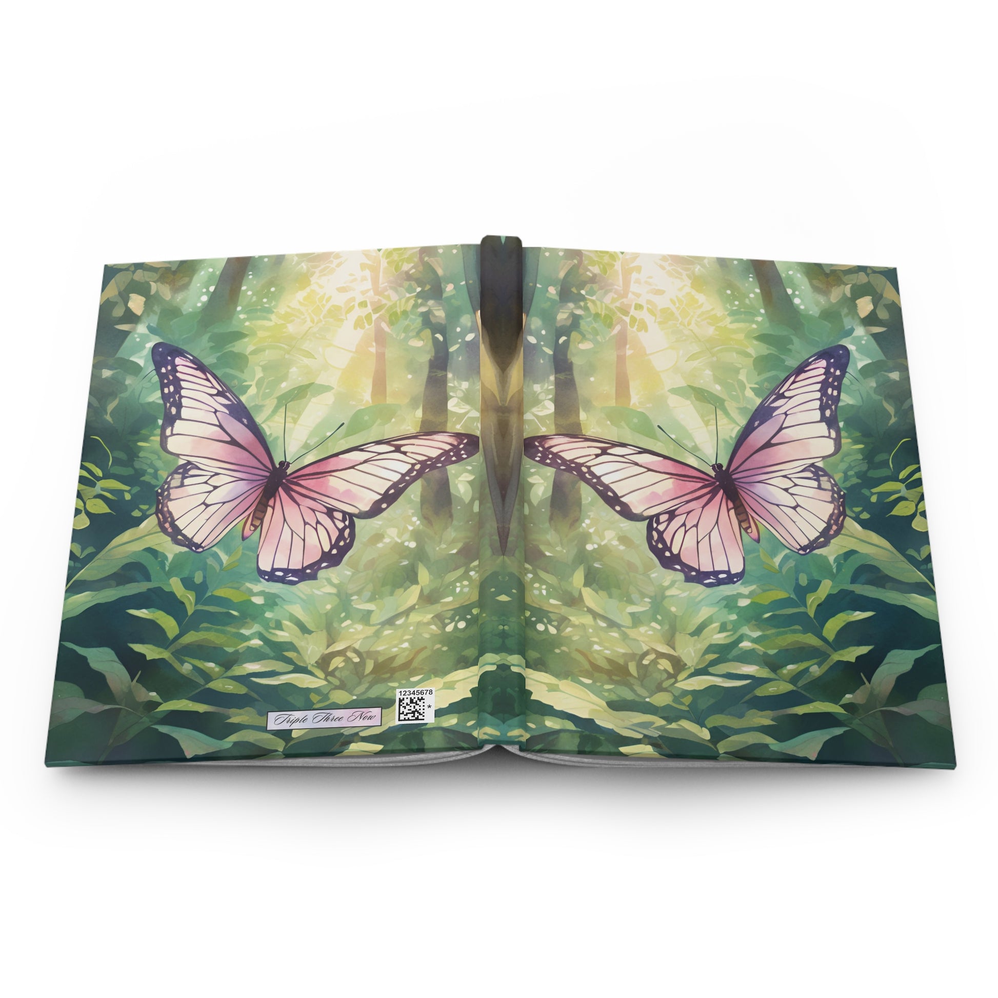 Book with a cover featuring two pink butterflies and a forest design.