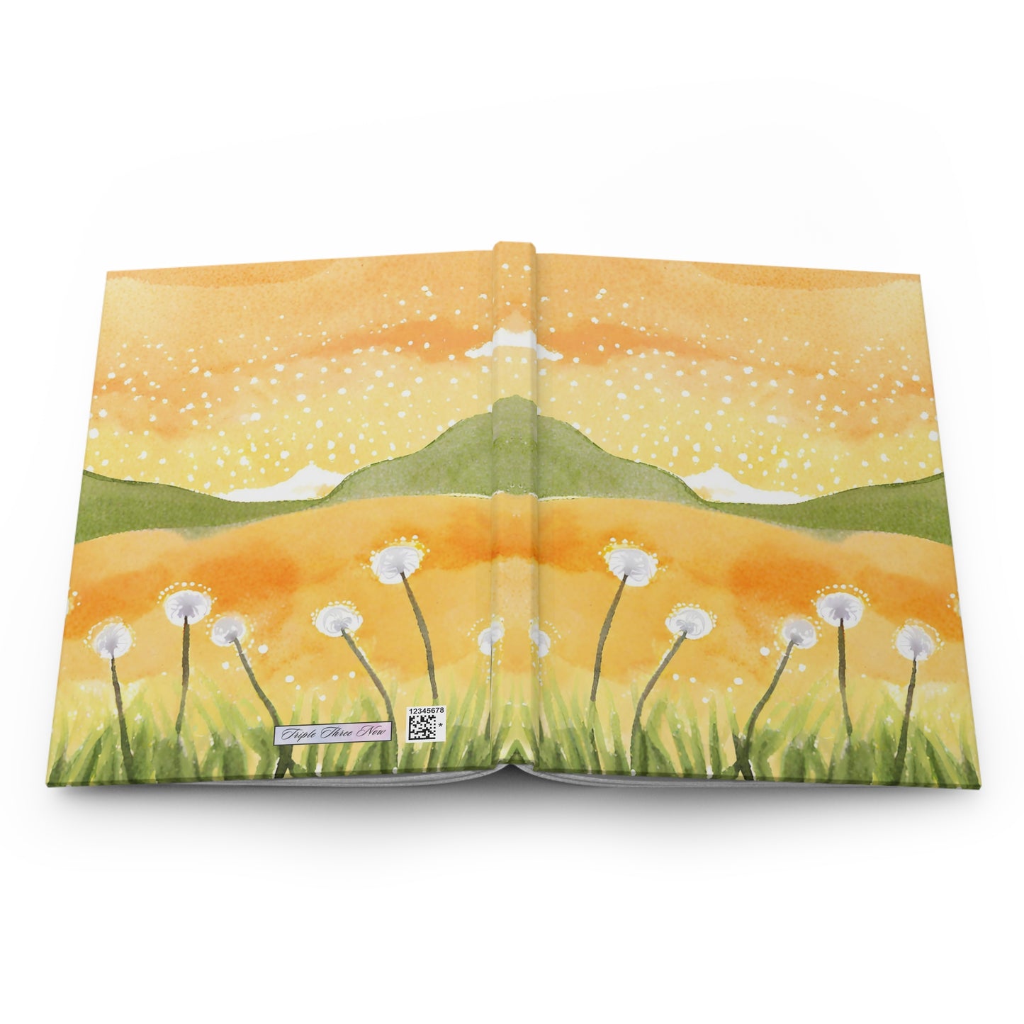 Open book with a landscape illustration of mountains and flowers on a yellow background