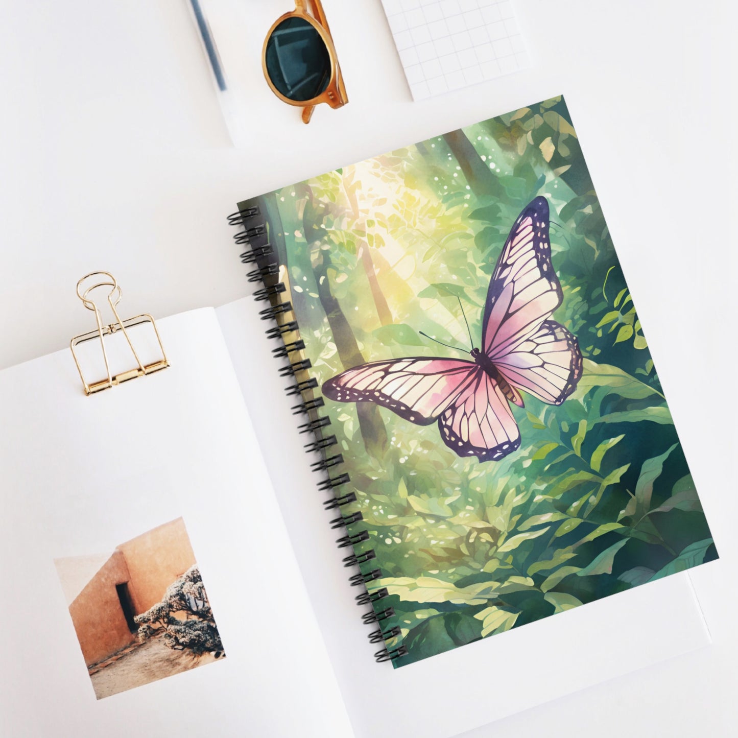 Notebook with butterfly design on a white surface