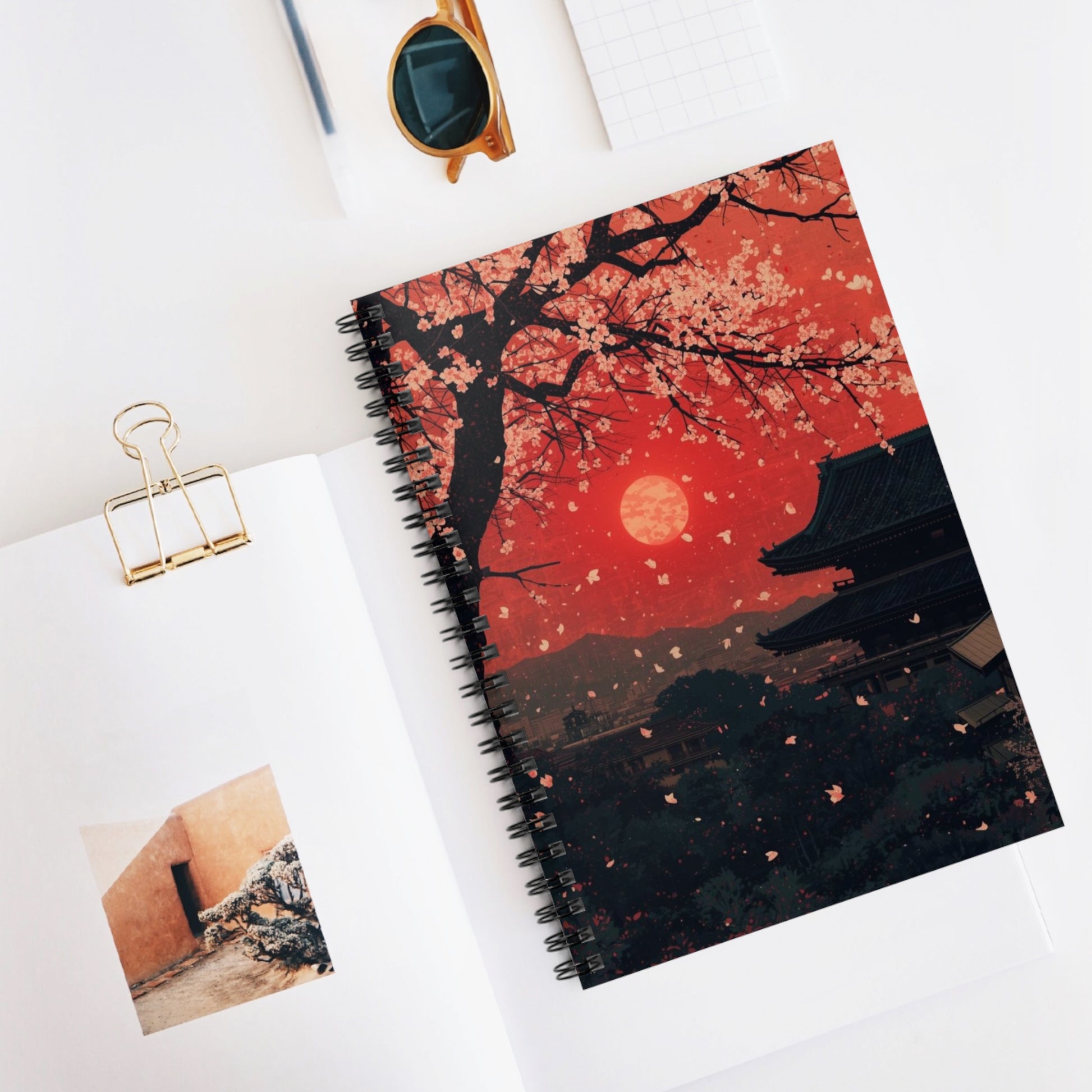 Notebook with cherry blossom design on a white surface