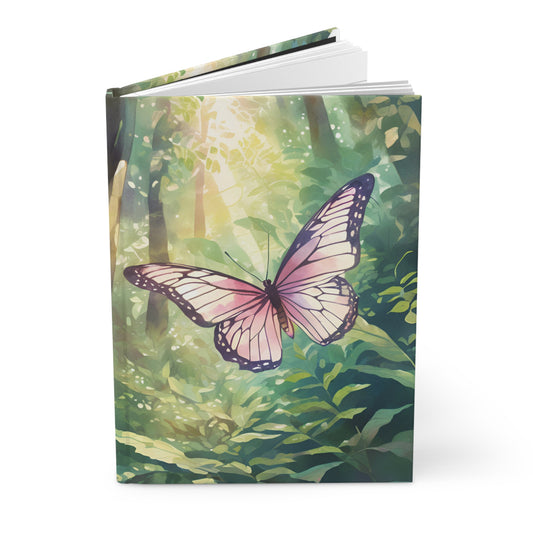 Notebook with a butterfly design on a green forest background
