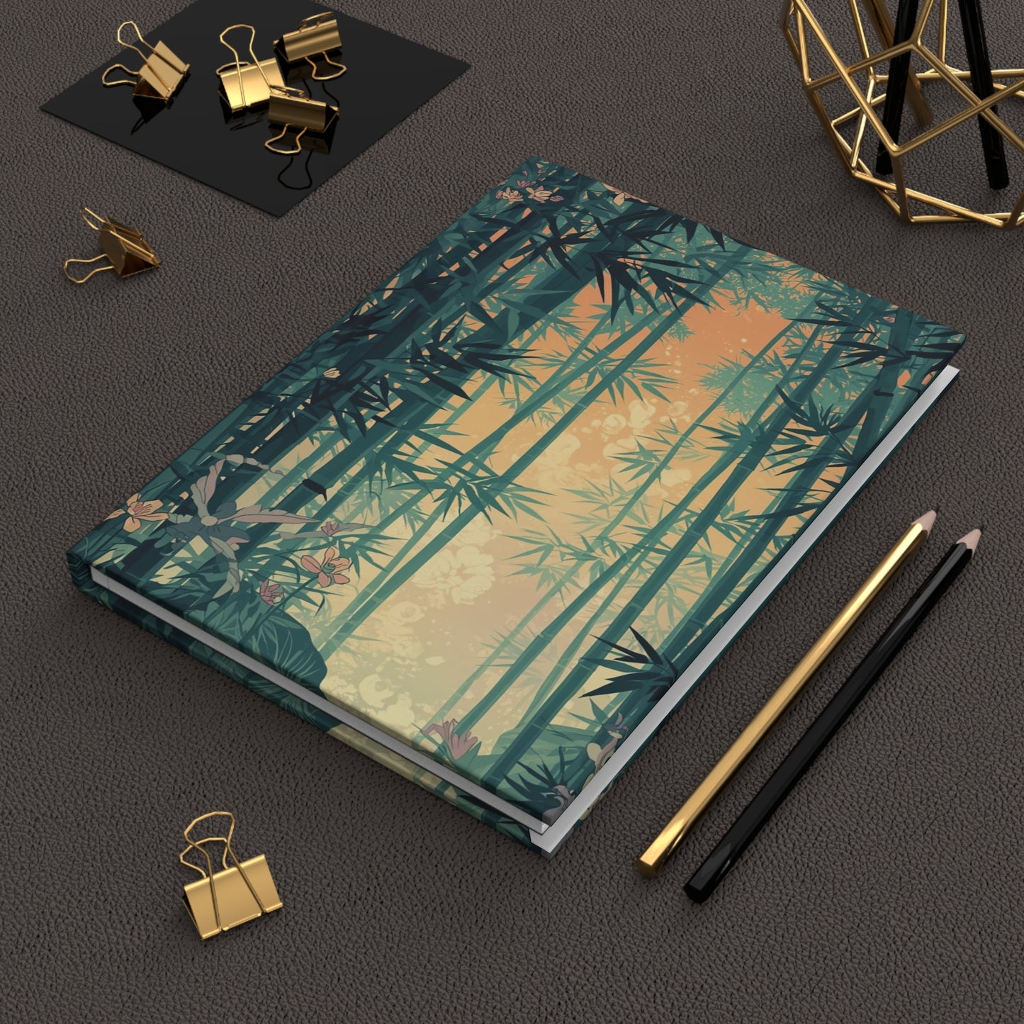 Notebook with bamboo design on a dark surface with office supplies