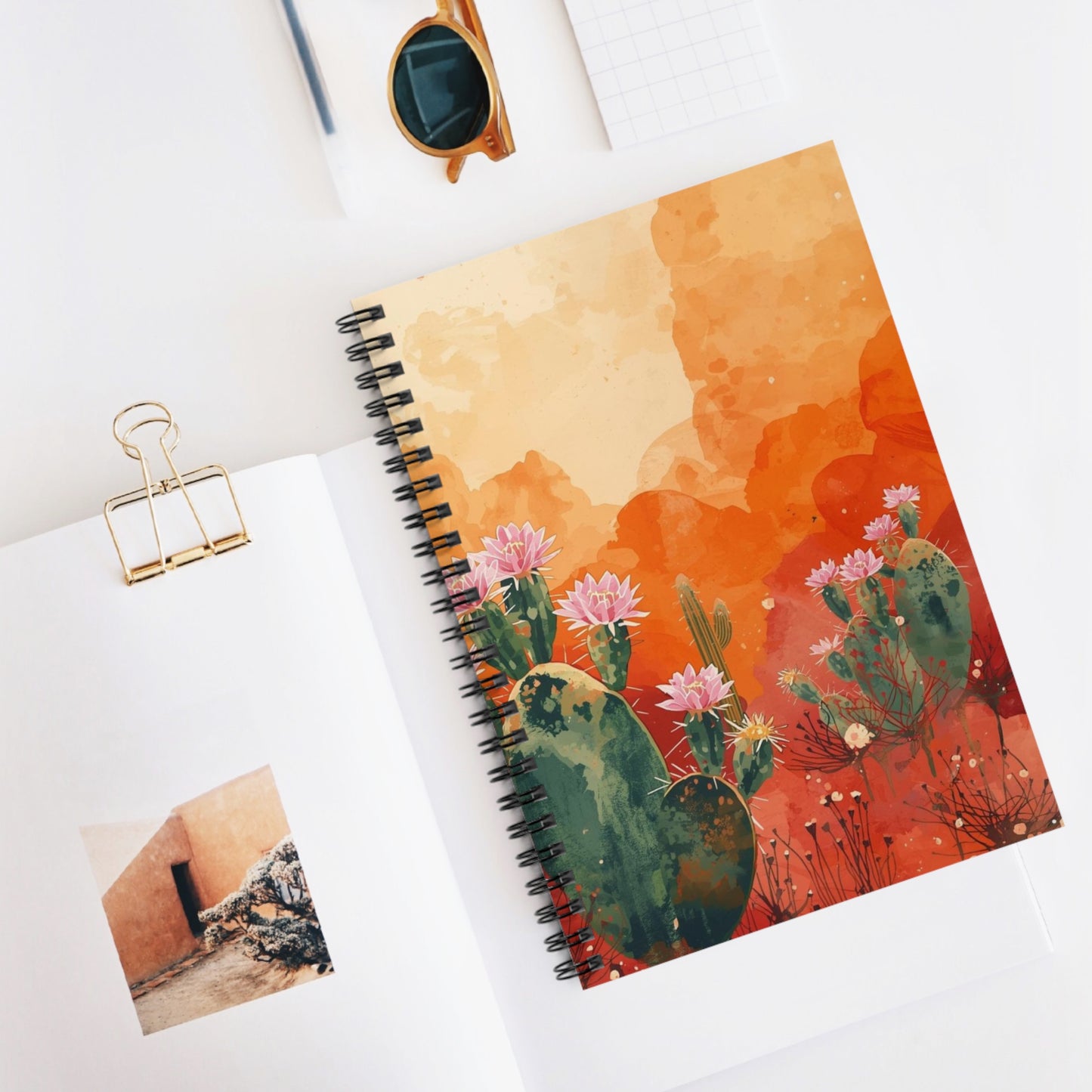 Notebook with cactus design on a white surface