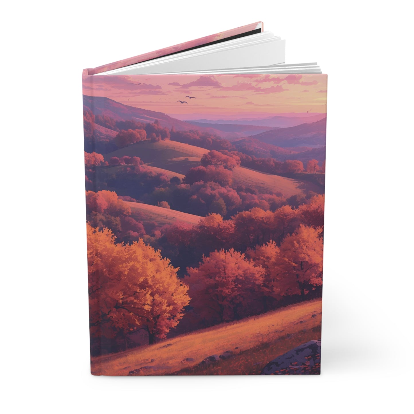 Book with a cover featuring a scenic landscape of trees and hills at sunset.