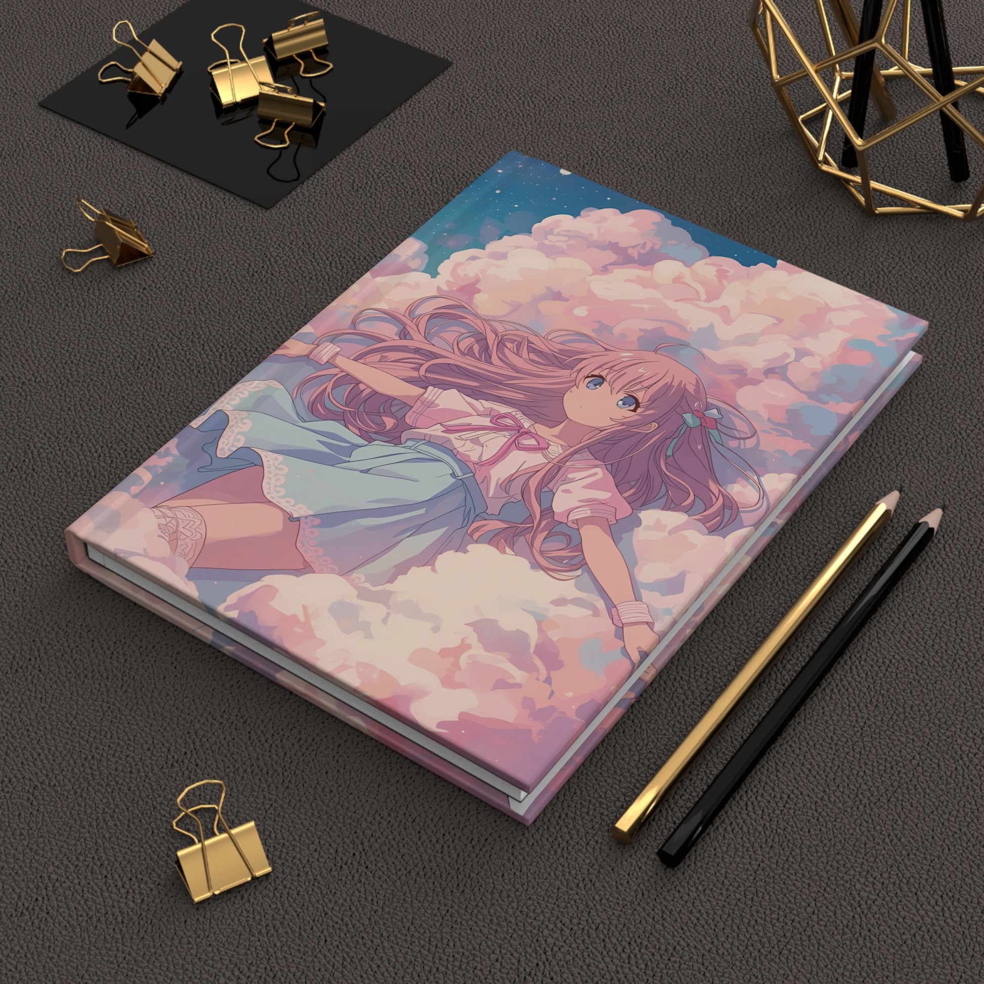 Notebook with an illustration of a girl on clouds, surrounded by stationery items on a dark surface.